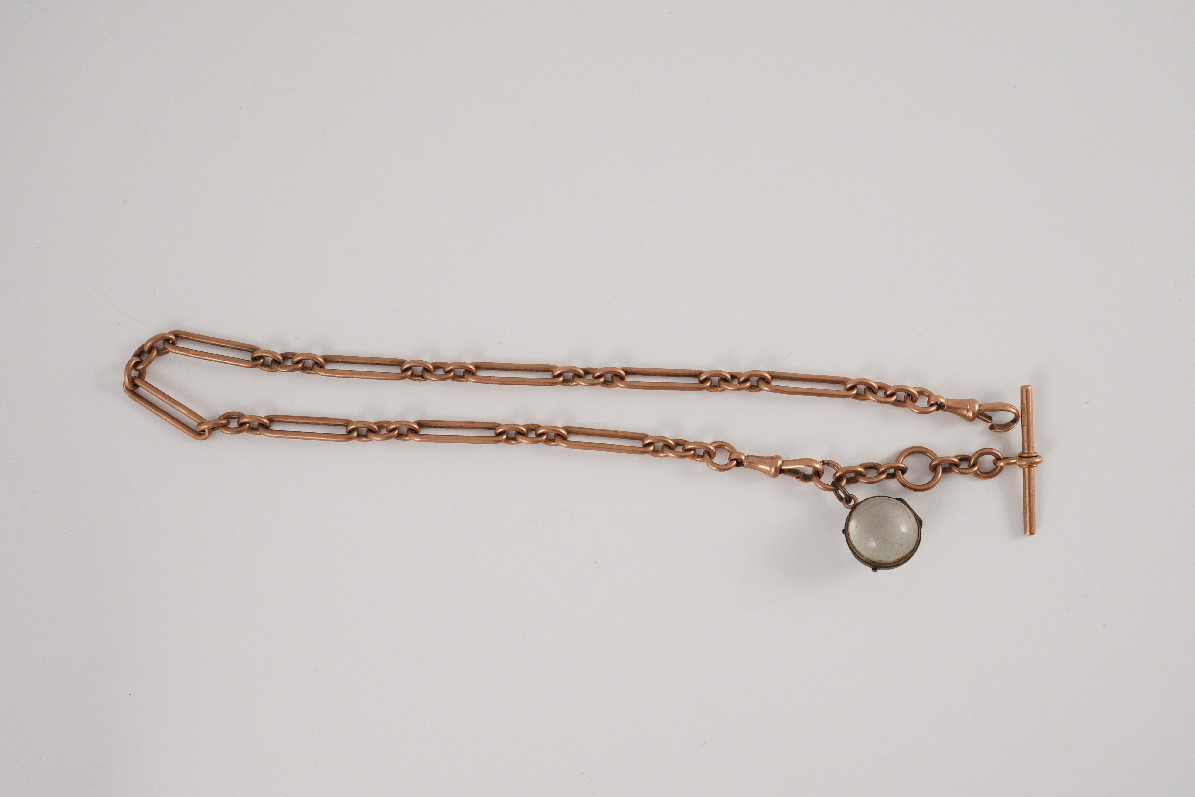 An early 20th century 9ct gold albert with magnified lens fob